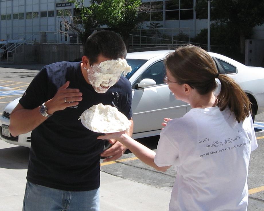 A student getting a pie shoved in their face to celebrate 