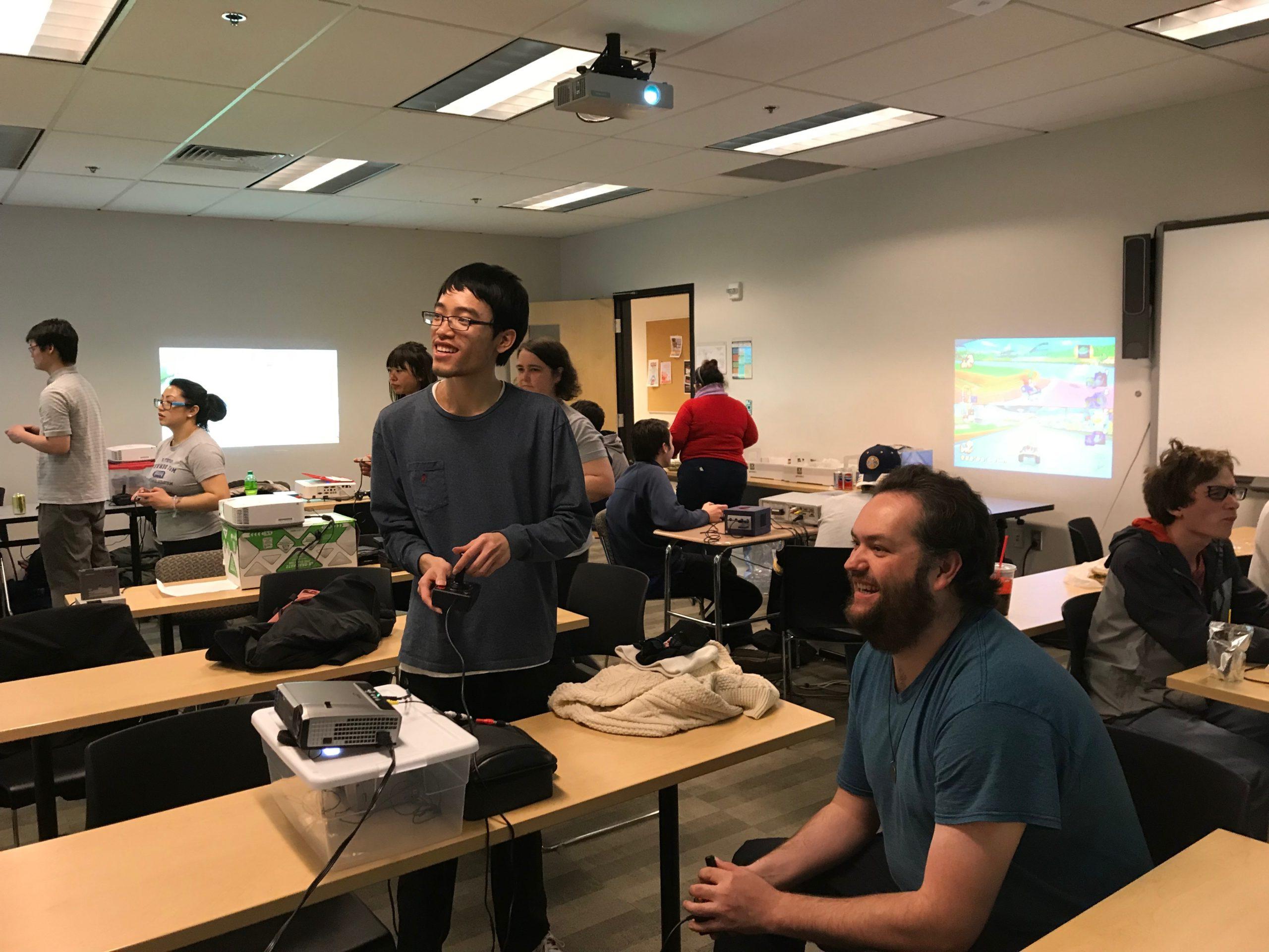 Students playing video games in a classroom during Retro Game Day