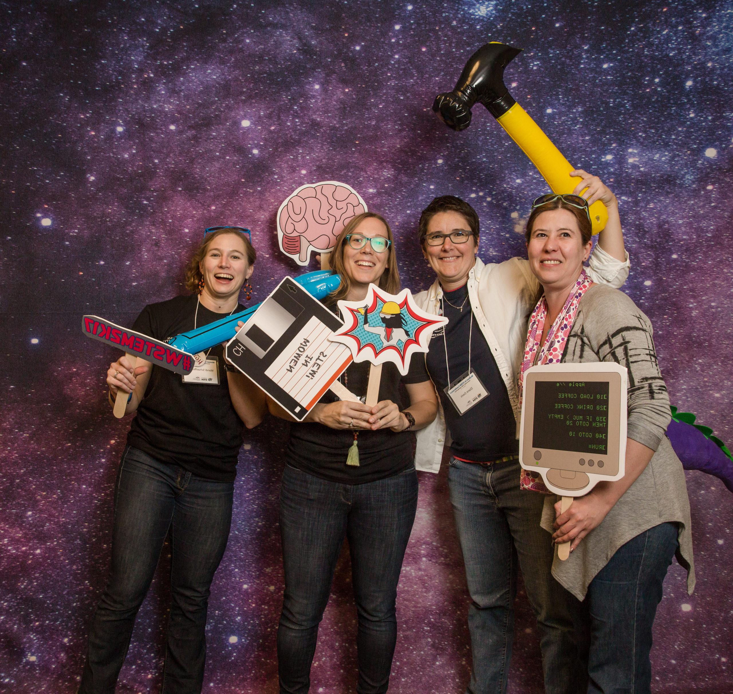 Math and Stats faculty taking a silly picture in front of a galaxy-themed backdrop.