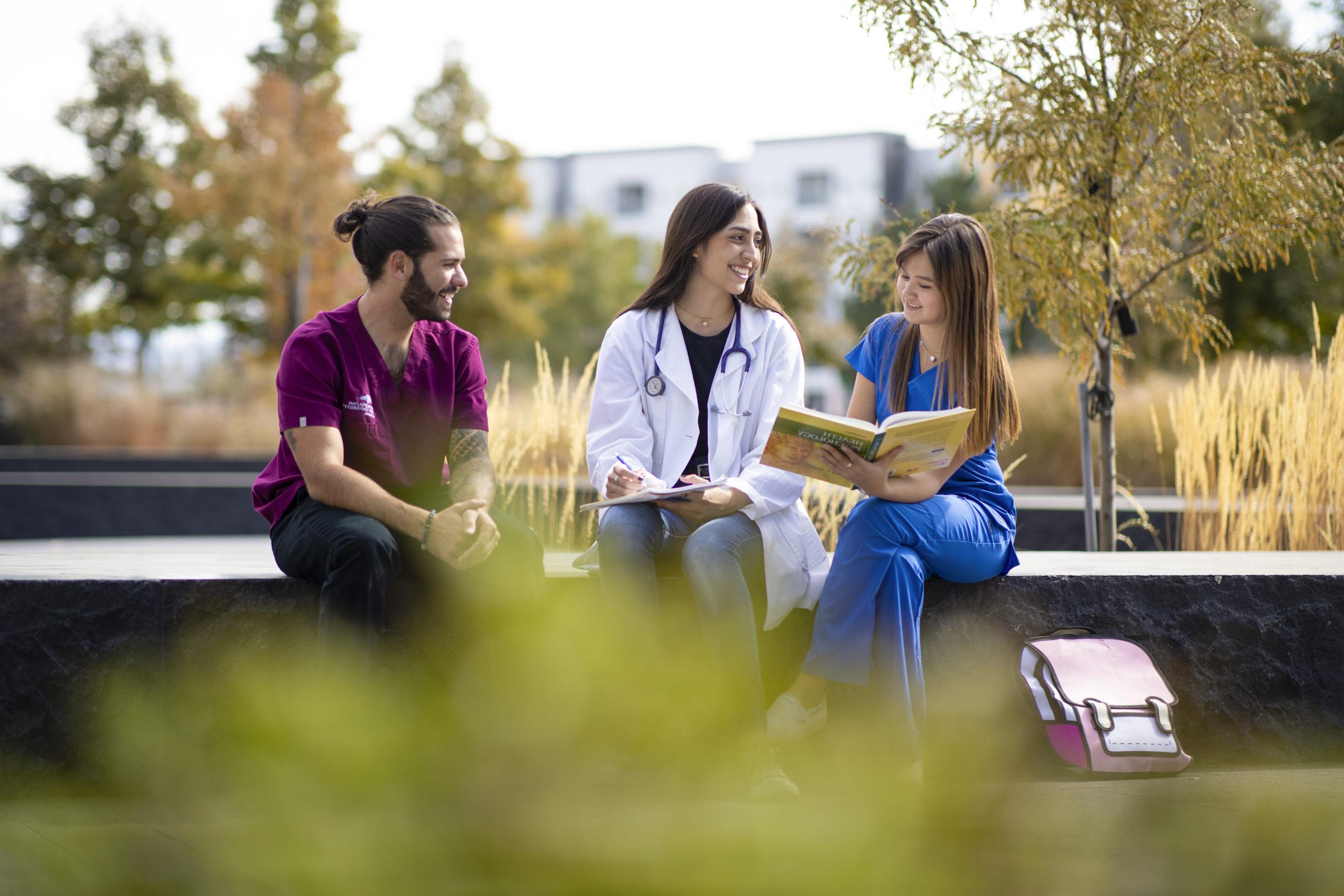 Three healthcare students studying on 密歇根州立大学丹佛's campus.