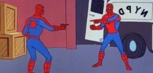 Two people dressed as Spider-Man pointing at each other.