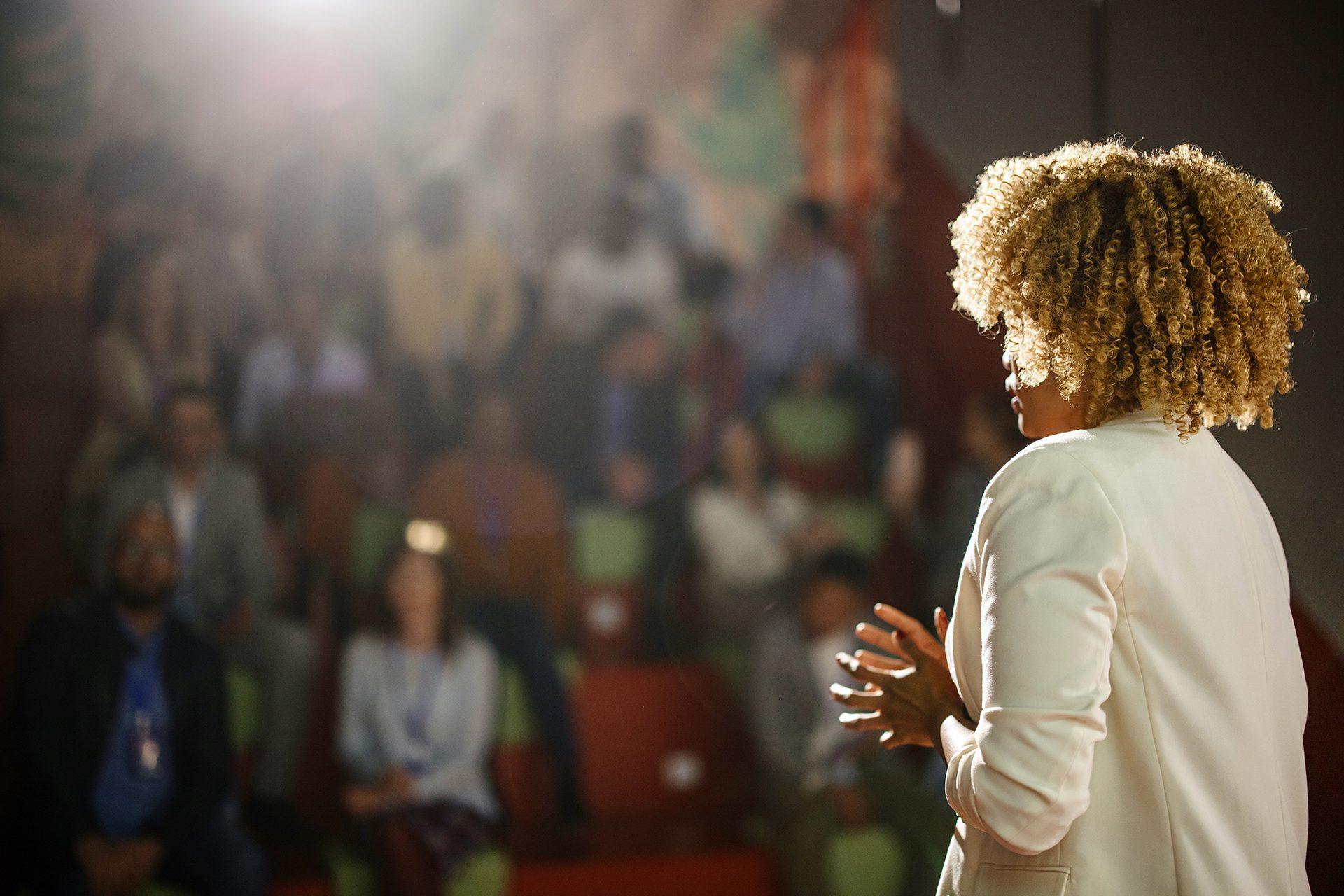 Woman giving a speech in an auditorium